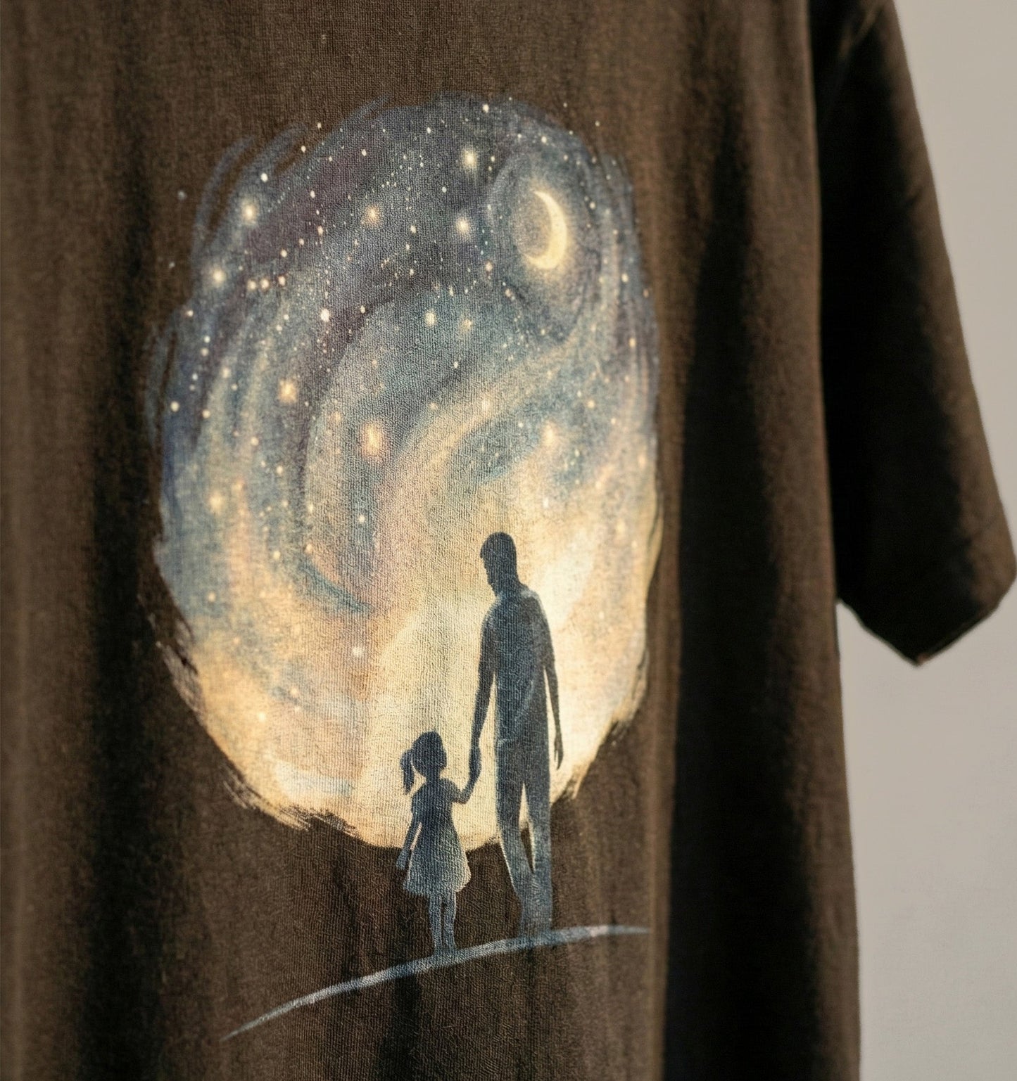 Brown t-shirt with a graphic of a man and a child standing on the moon. [KyaScene]